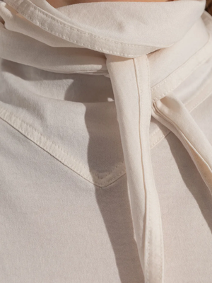 Close up of tan T-shirt, showing texture of the cotton fabric