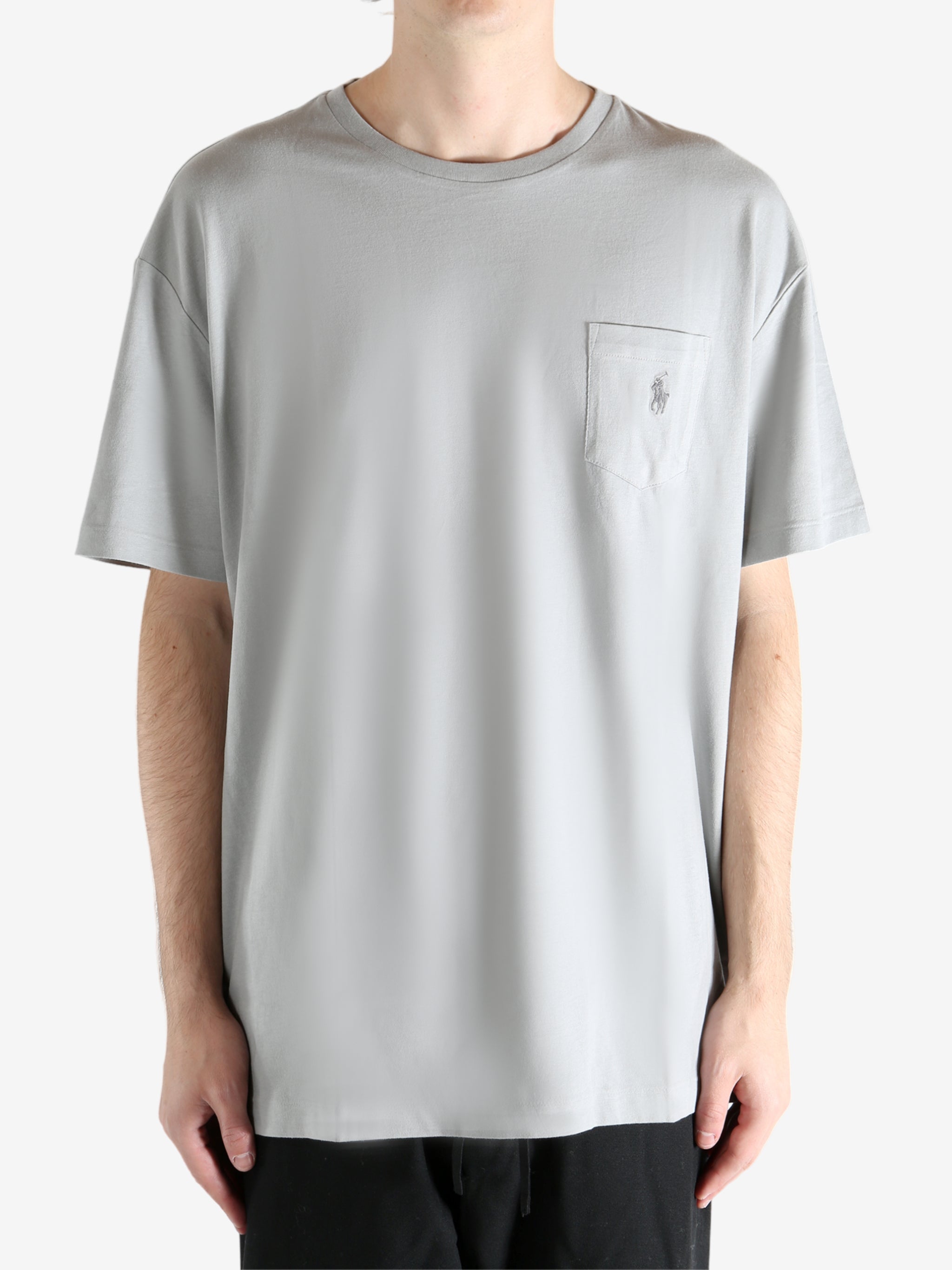 Grey t-shirts worn by a person, showing the t-shirts fit