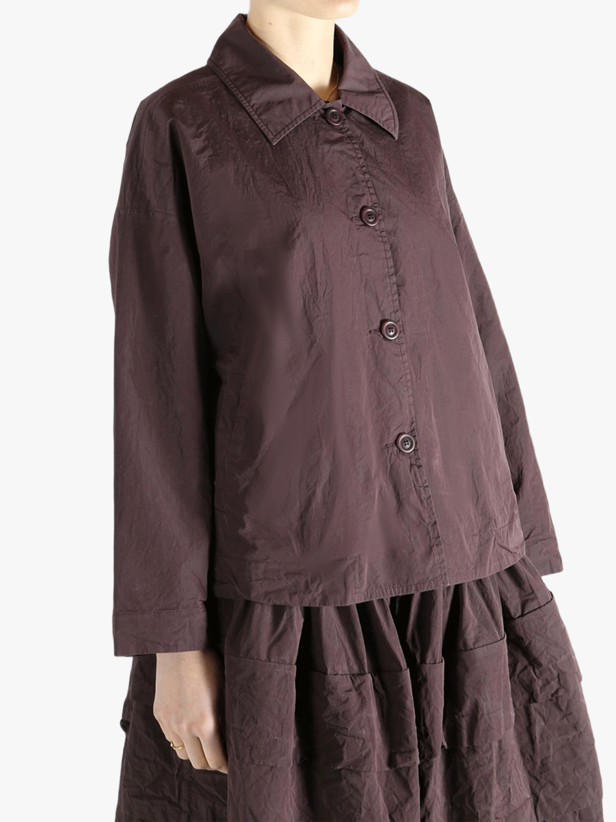 Brown jackets-coats worn by a person, showing the jackets-coats'fit