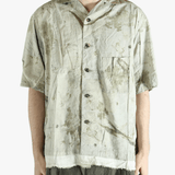 Green shirt worn by a person, showing the shirt's fit