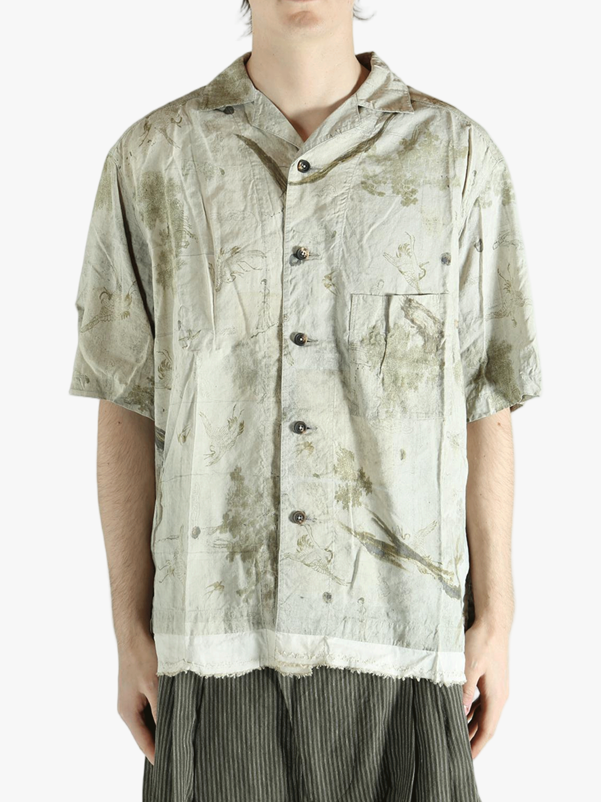 Green shirt worn by a person, showing the shirt's fit