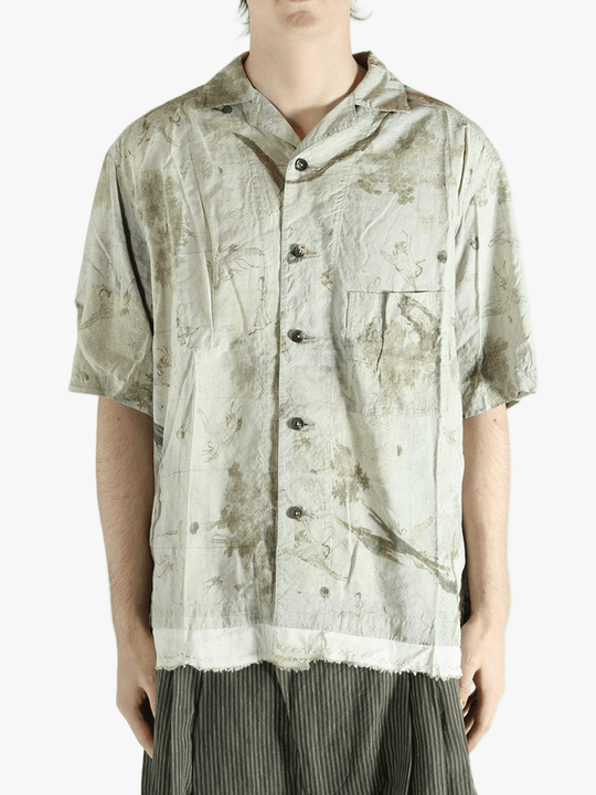 Green shirt worn by a person, showing the shirt's fit