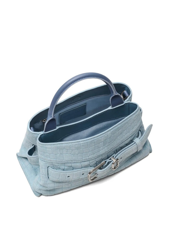 Close up of blue bags, showing texture of the suede cow leather fabric