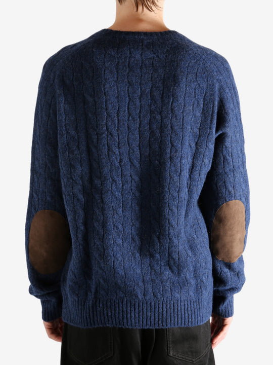 Navy sweater worn by a person, showing the sweater's fit