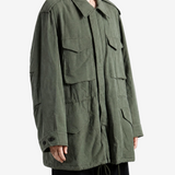 Green jacket worn by a person, showing the jacket fit