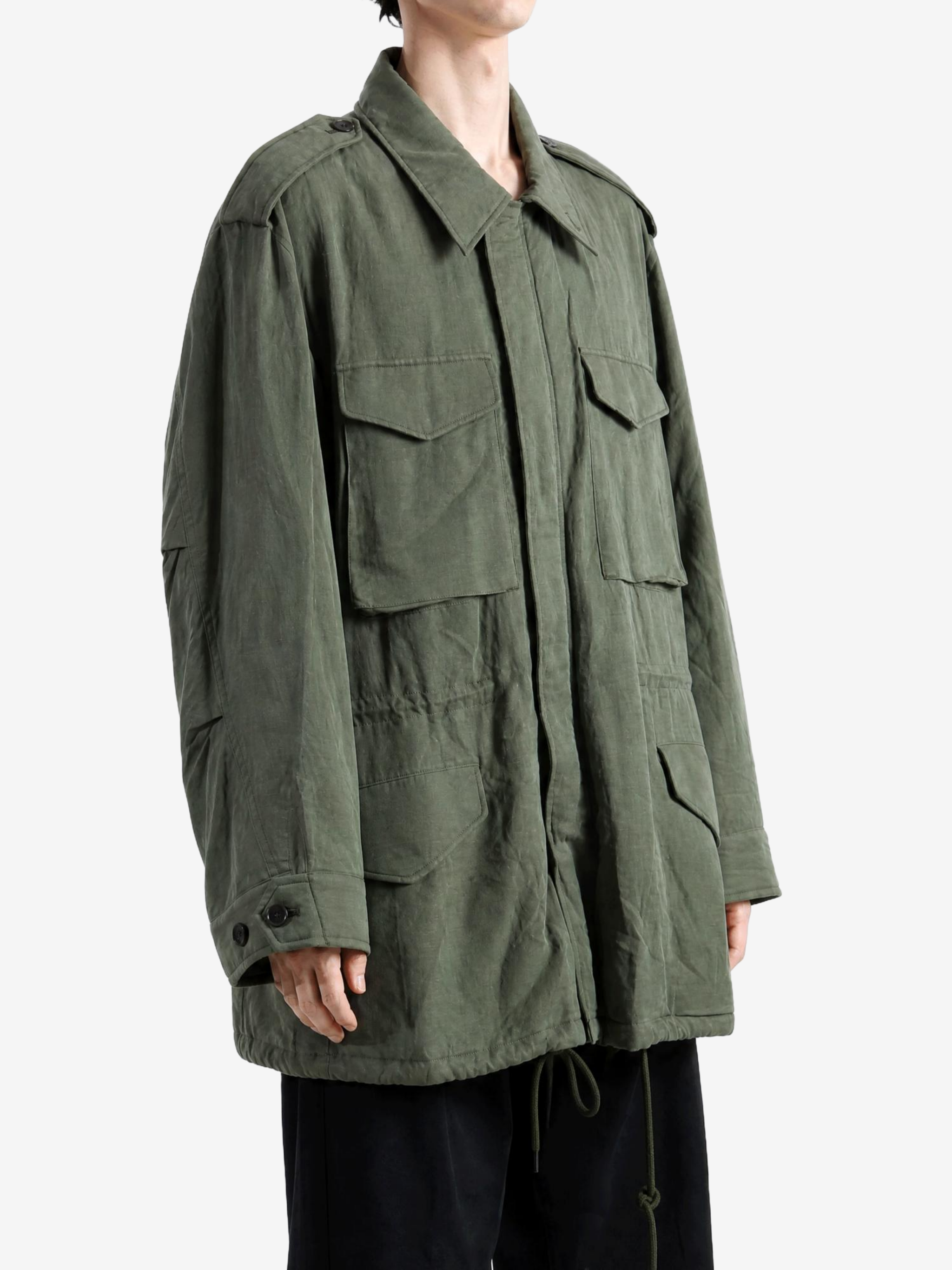 Green jacket worn by a person, showing the jacket fit