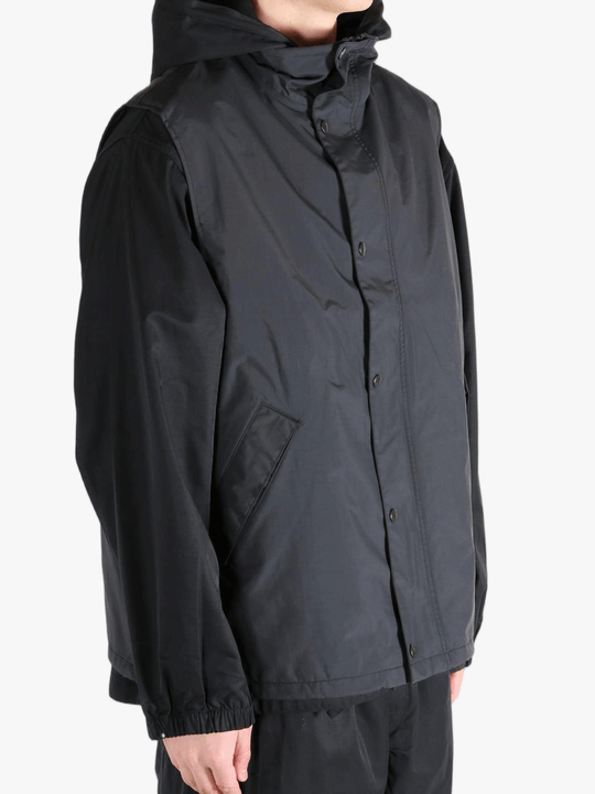 Black top worn by a person, showing the top's fit