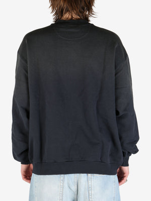 Black sweater worn by aperson, showing the sweater's fit