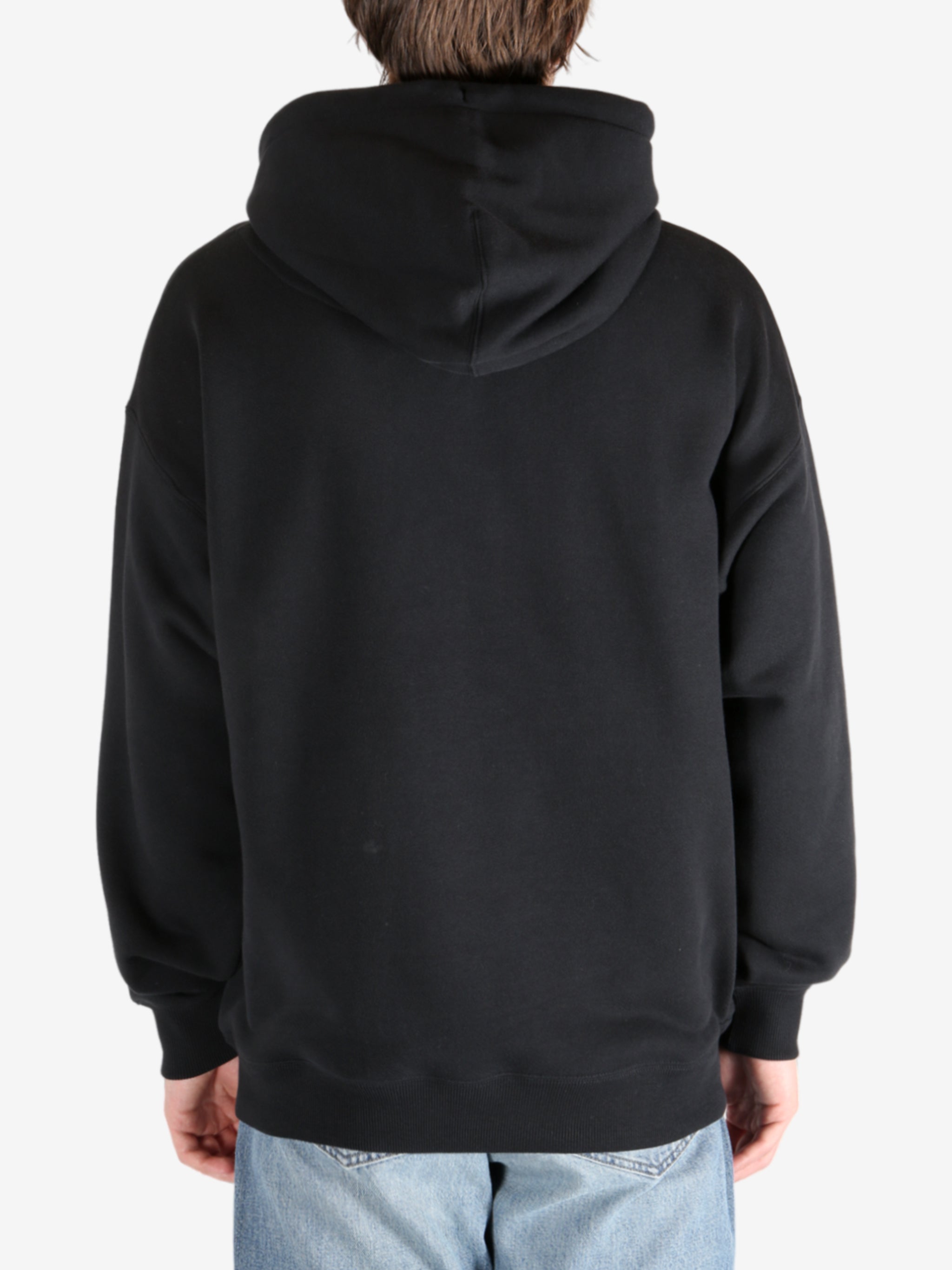 Black hoodie worn by a person, showing the hoodie's fit