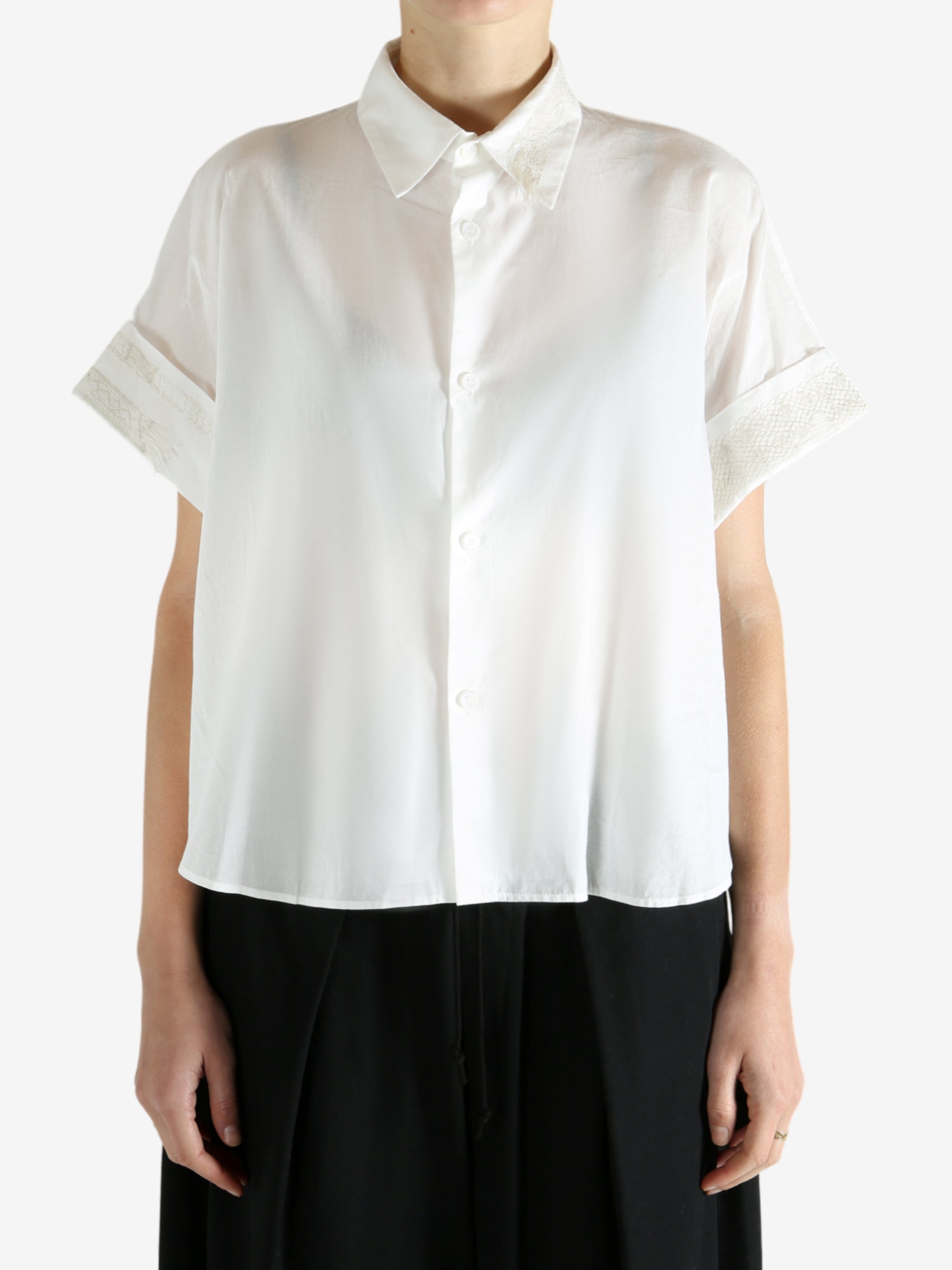 White shirts worn by a person, showing the shirts fit