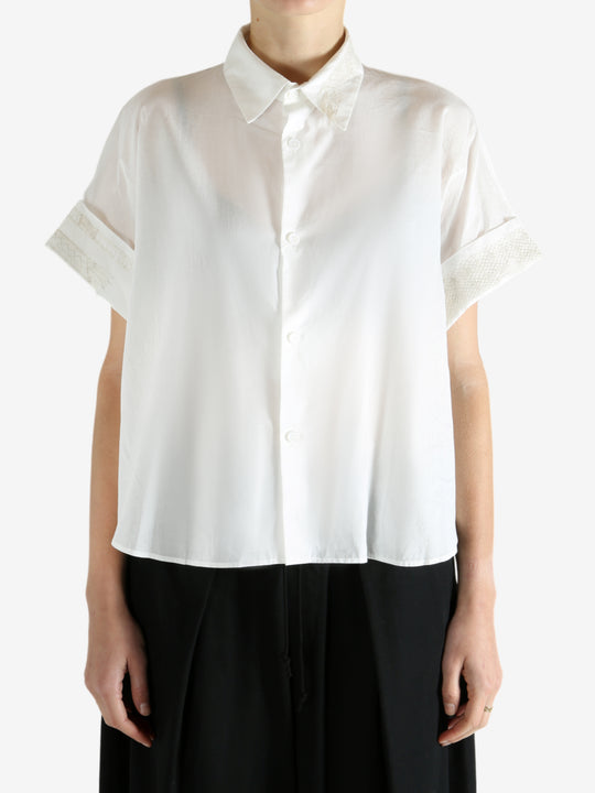 White shirts worn by a person, showing the shirts fit