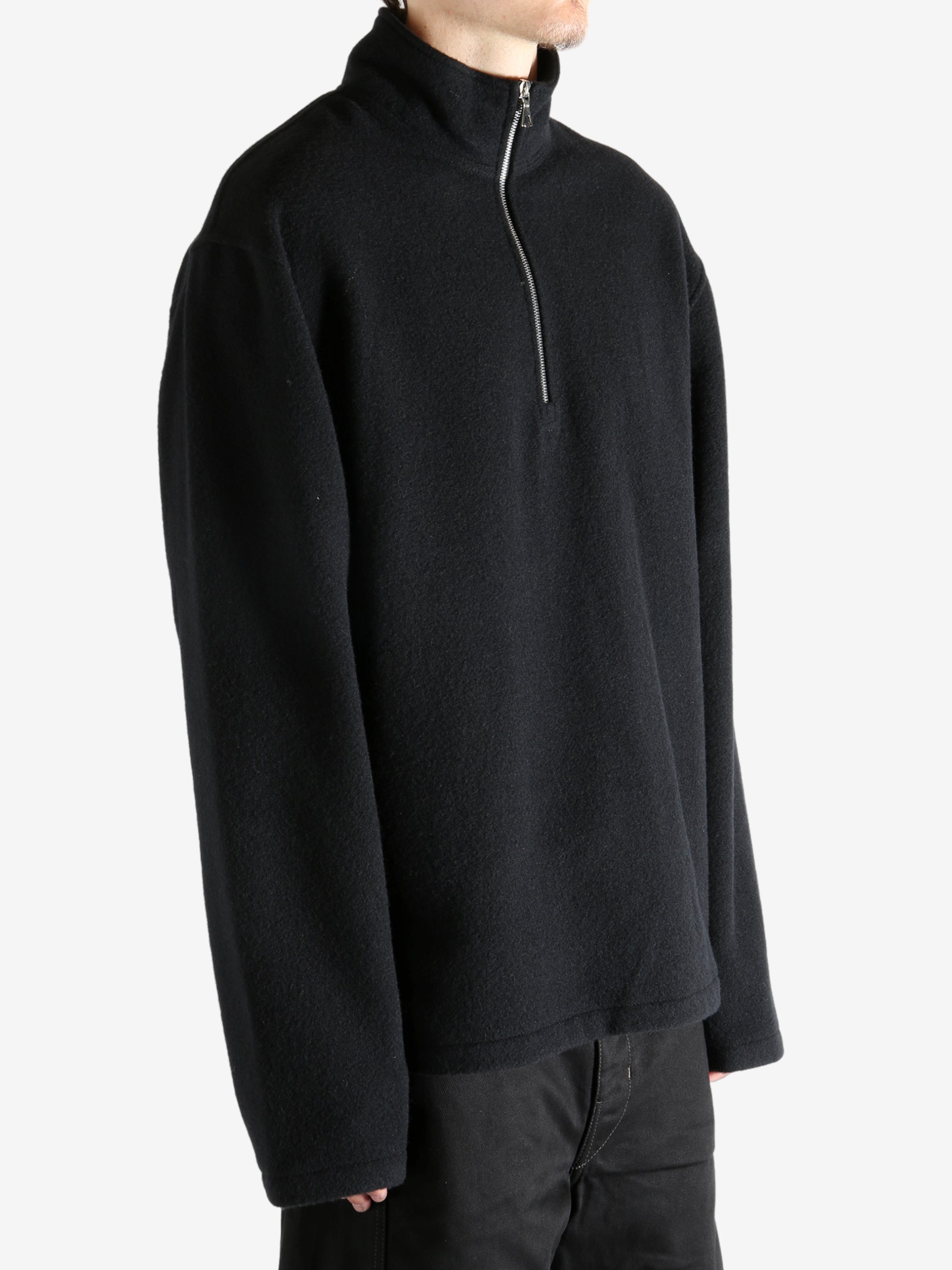 Black shirt worn by a person, showing the shirt's fit