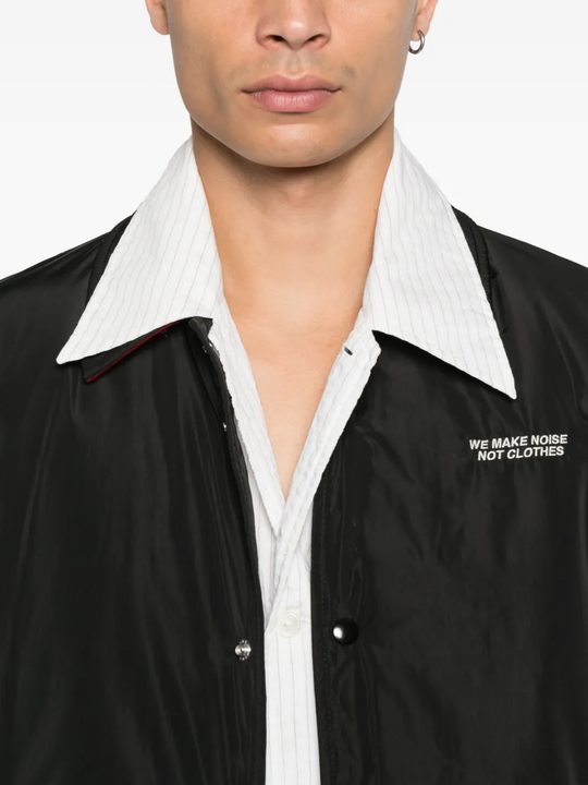 Close up of the black jacket, showing texture of the polyester fabric