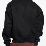 Black jacket worn by a person, showing the jacket's fit