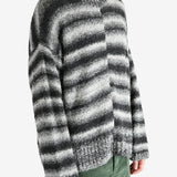 Black knitwear worn by a person, showing the knitwear's fit