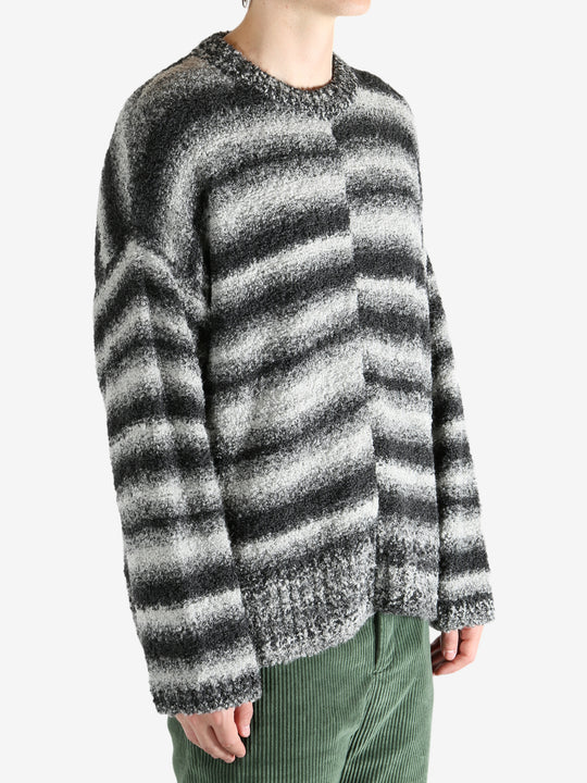 Black knitwear worn by a person, showing the knitwear's fit