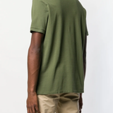 Green t-shirt worn by a person, showing the t-shirt fit
