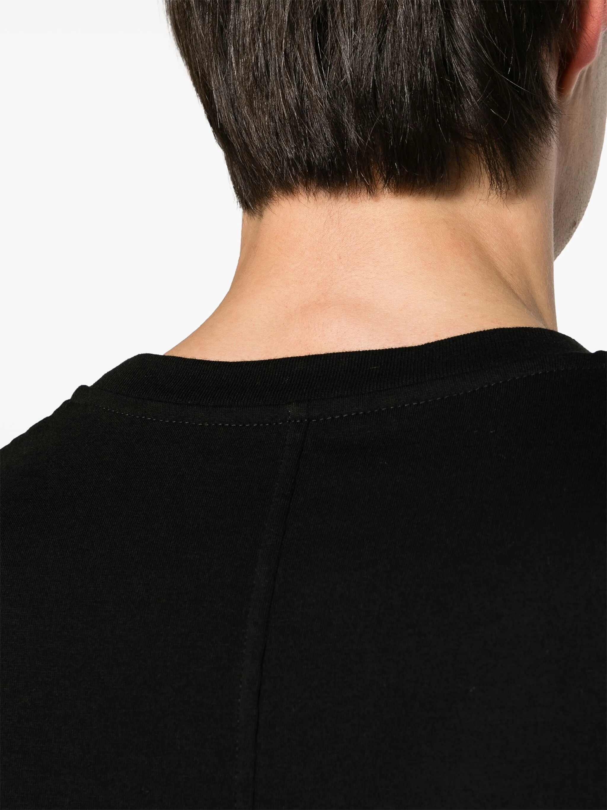 Close up of black t-shirt, showing texture of the cotton fabric