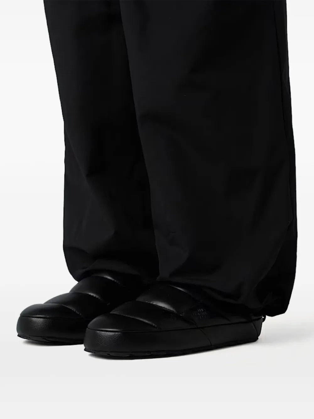 Black mule worn by a person, showing the mule's fit
