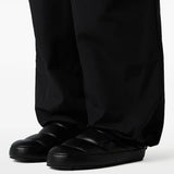Black mule worn by a person, showing the mule's fit