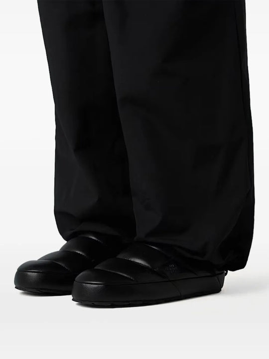 Black mule worn by a person, showing the mule's fit