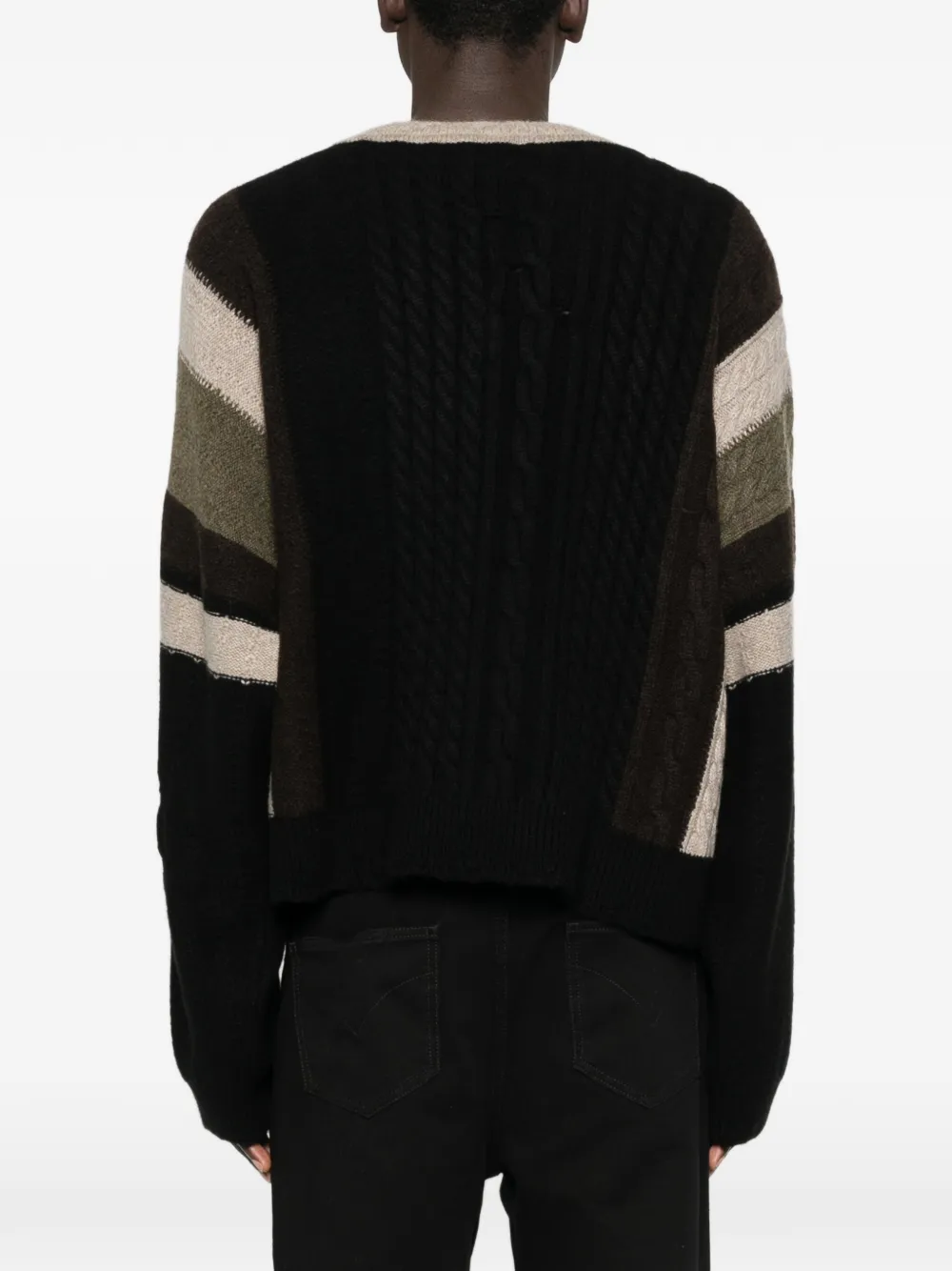 Black sweater worn by a person, showing the sweater fit