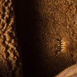 Close up of brown bag, showing texture of the sheep skin fabric