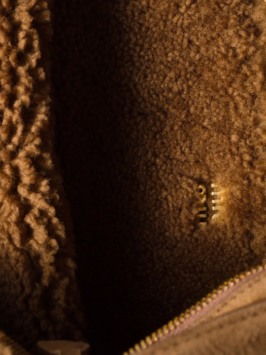 Close up of brown bag, showing texture of the sheep skin fabric