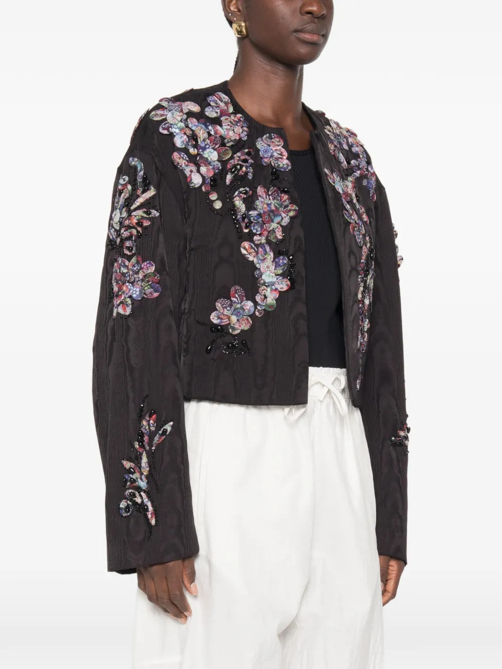 Black jacket worn by a person, showing the jacket fit