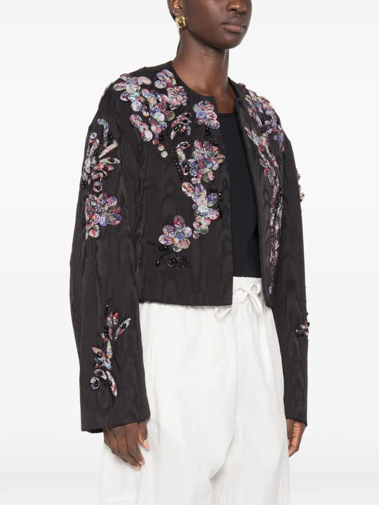 Black jacket worn by a person, showing the jacket fit