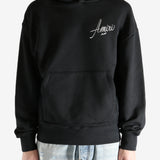 Black hoodie worn by a person, showing the hoodie fit