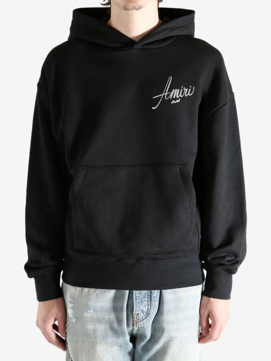 Black hoodie worn by a person, showing the hoodie fit