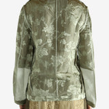 Green jacket worn by a person, showing the jacket fit