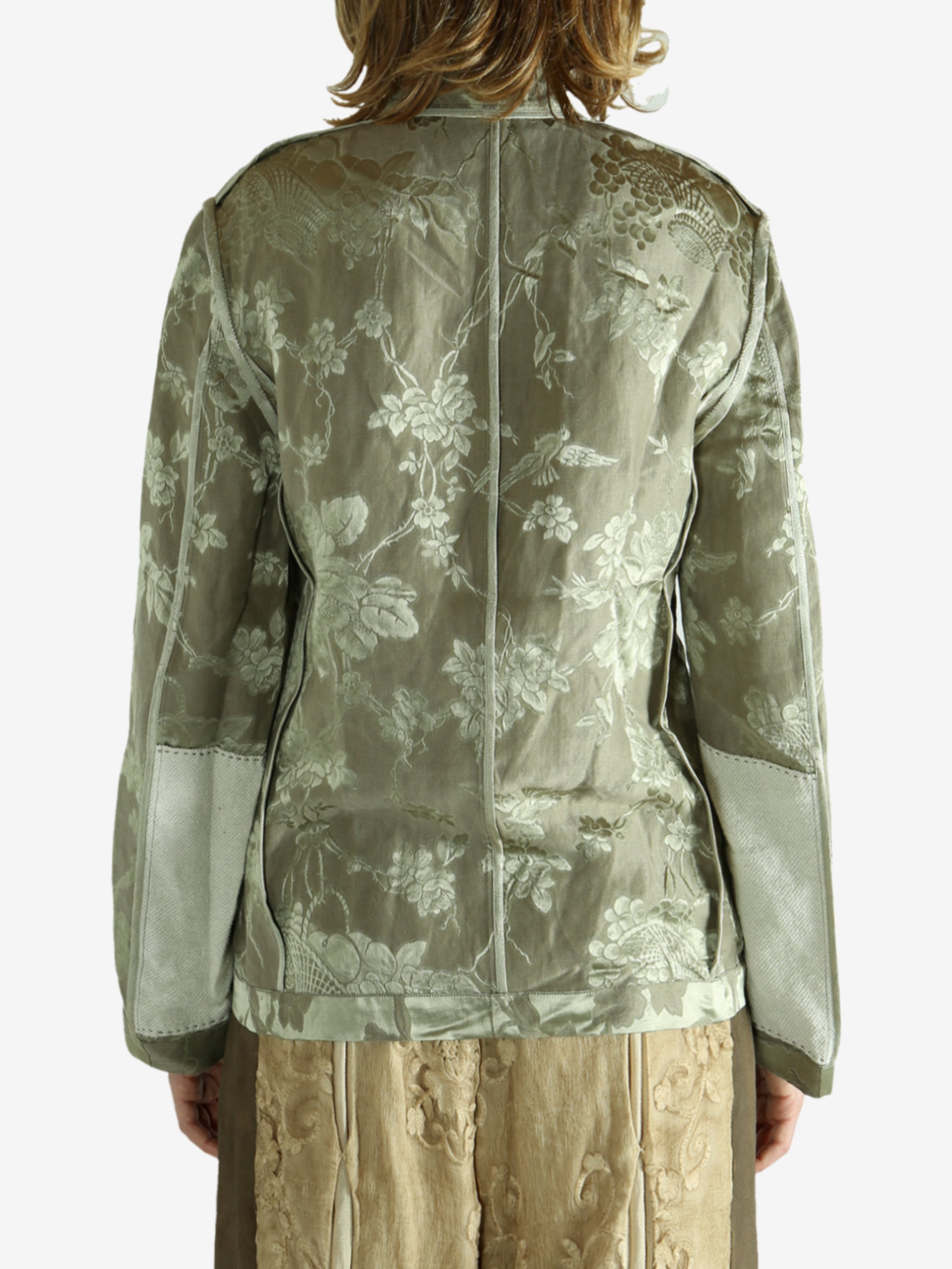 Green jacket worn by a person, showing the jacket fit