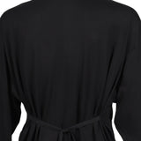Black top worn by a person, showing the top fit