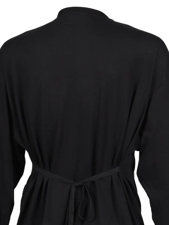 Black top worn by a person, showing the top fit