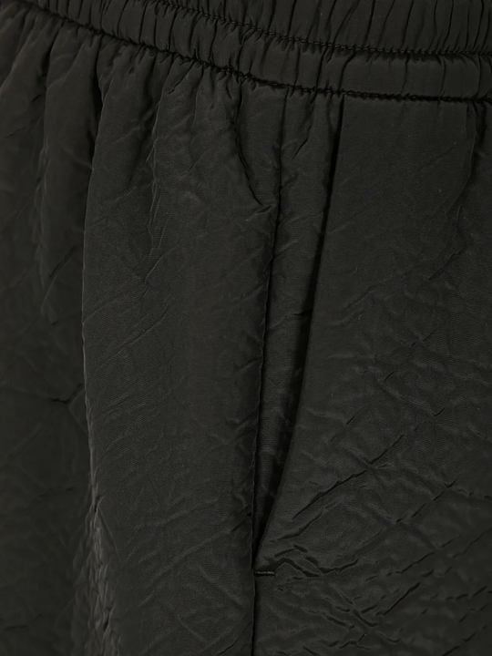 Close up of the black short, showing texture of the polyester fabric