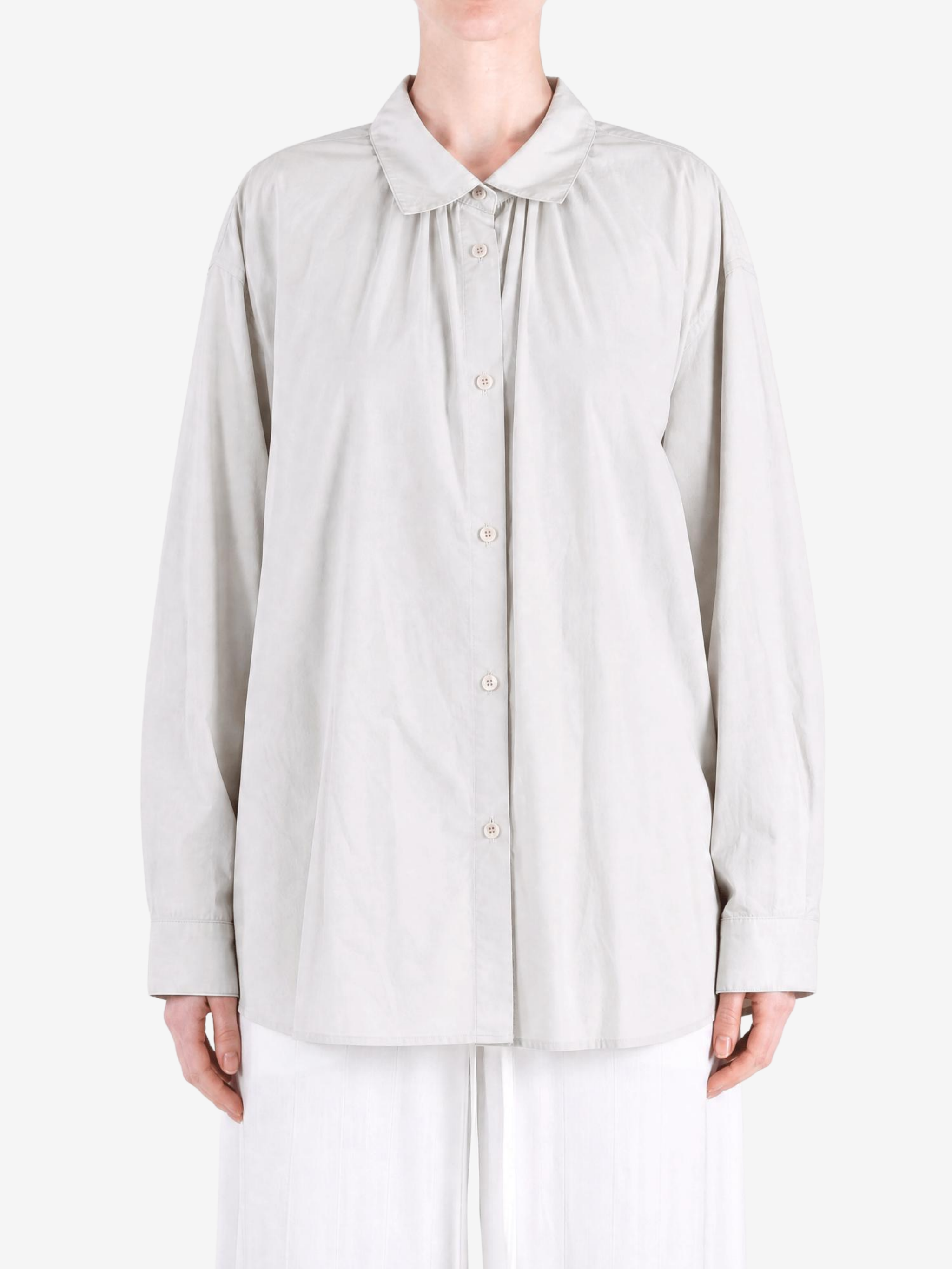 Grey shirt worn by a person, showing the shirt fit