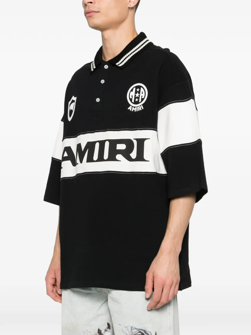 Black T-shirt worn by a person, showing the t-shirt's fit