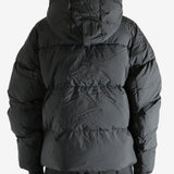 Black coat worn by a person, showing the coat's fit