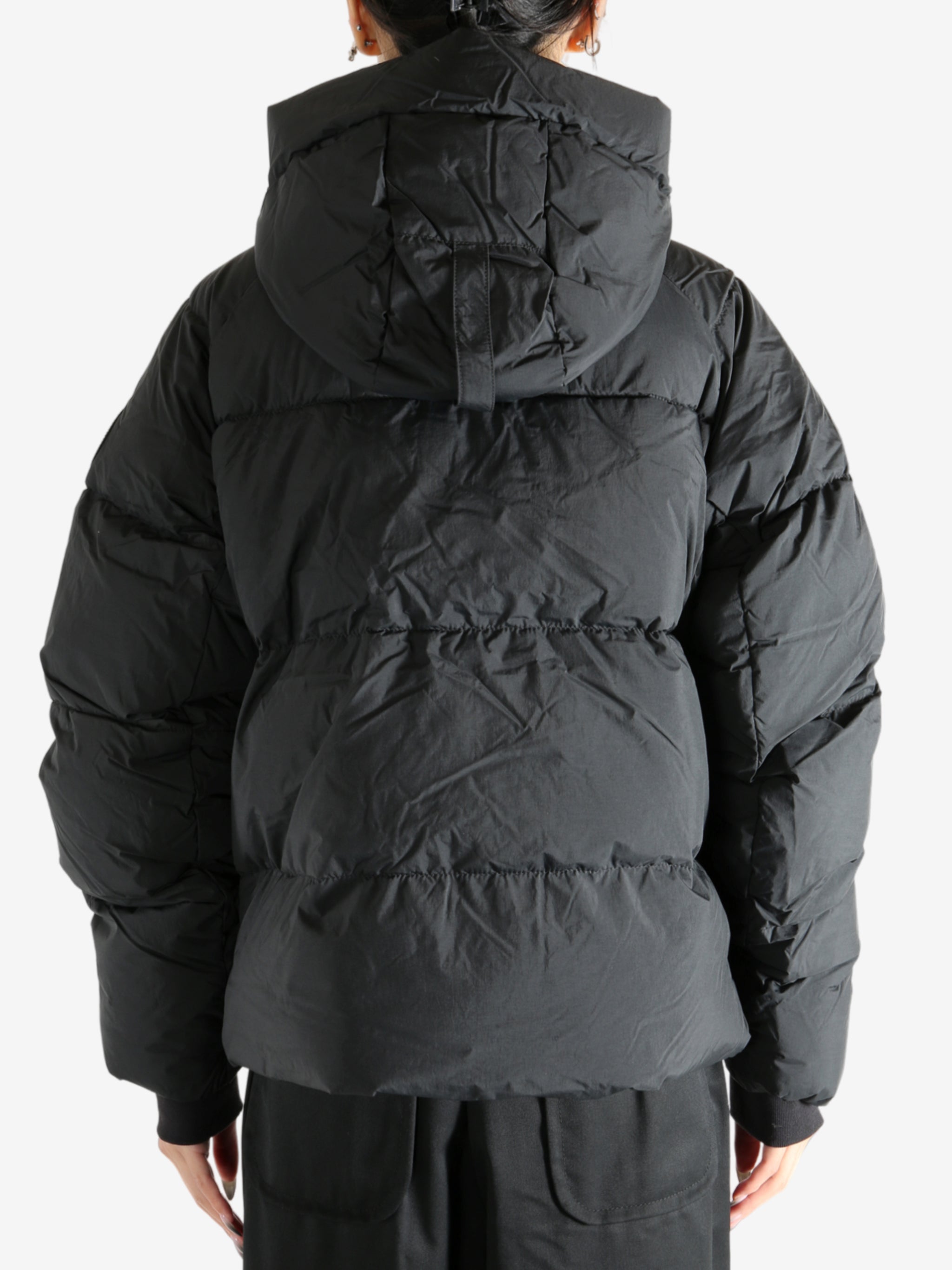 Black coat worn by a person, showing the coat's fit