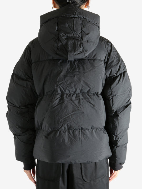 Black coat worn by a person, showing the coat's fit