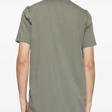 green t-shirts,worn by a person,showing the t-shirts fit