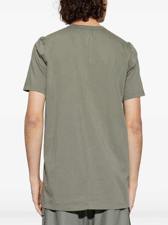 green t-shirts,worn by a person,showing the t-shirts fit