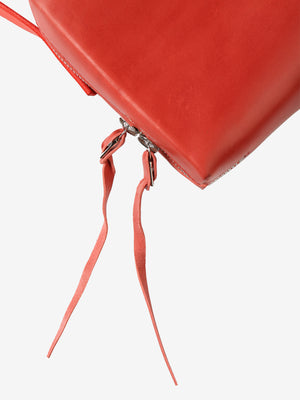 Close up of red bag, showing zipper of the bag