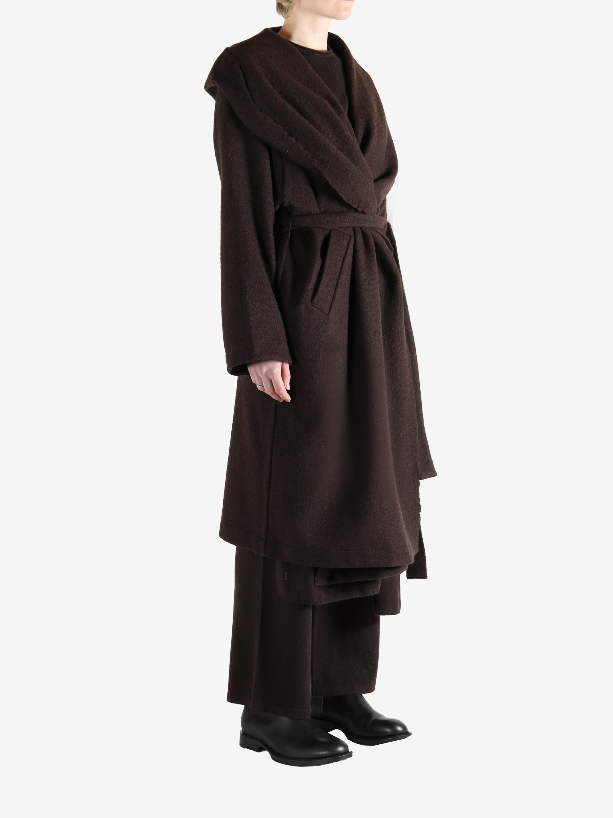 Brown coat worn by a person, showing the coat fit