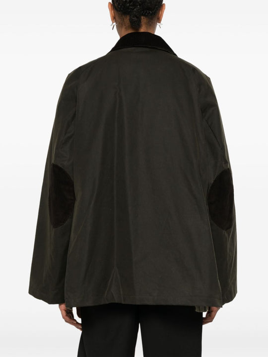 Green jacket worn by a person, showing the jacket’s fit