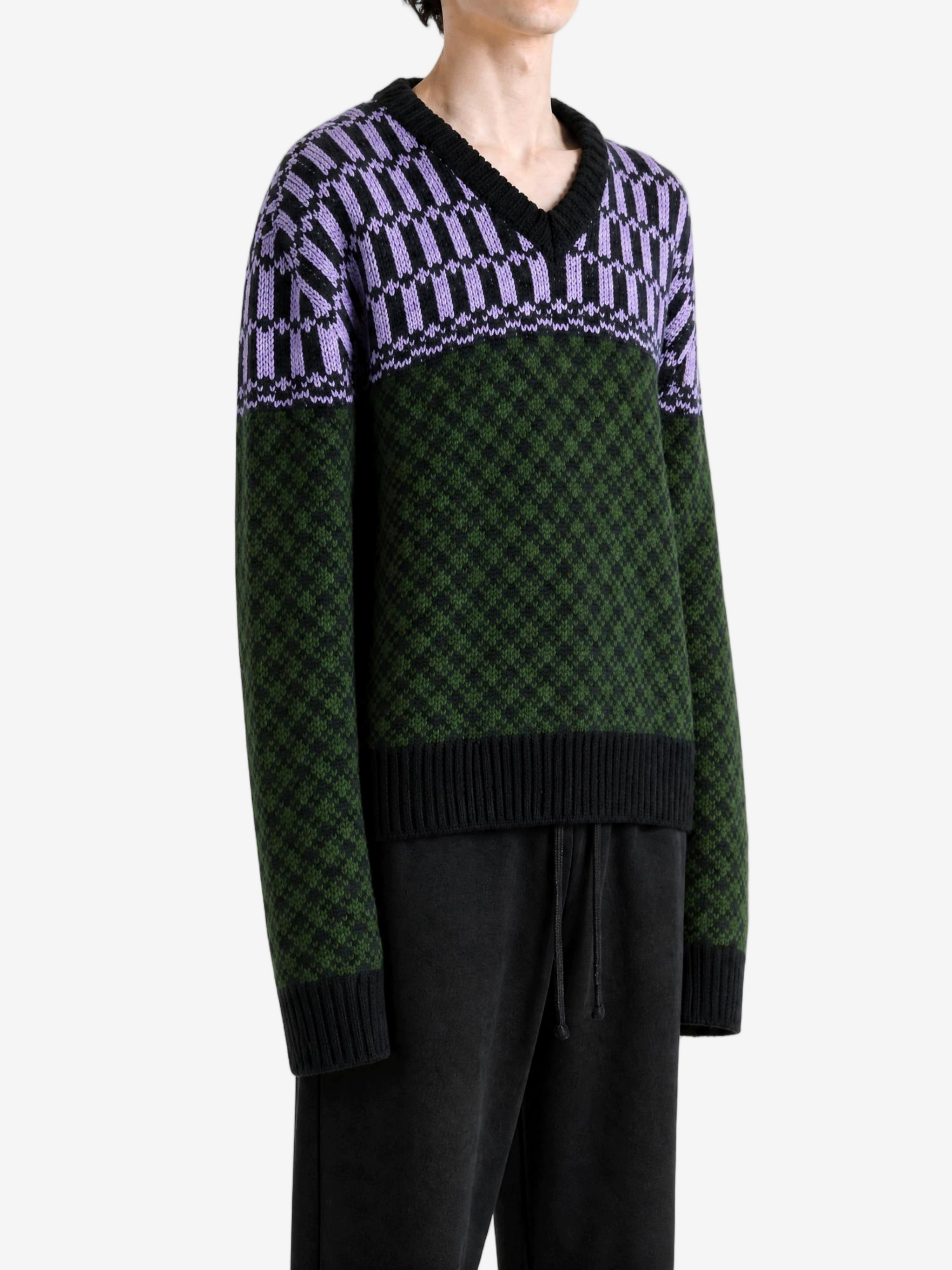 Green knitwear worn by a person, showing the knitwear fit