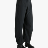 Black pants worn by a person, showing the pants' fit