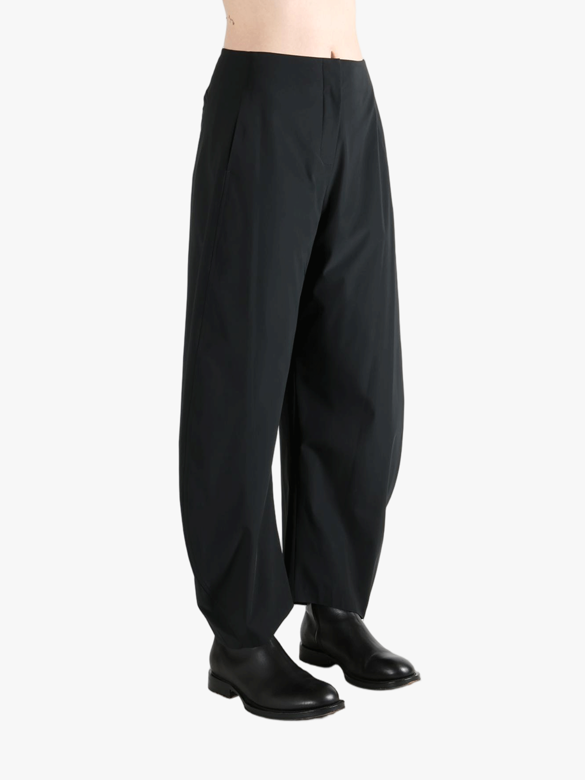 Black pants worn by a person, showing the pants' fit